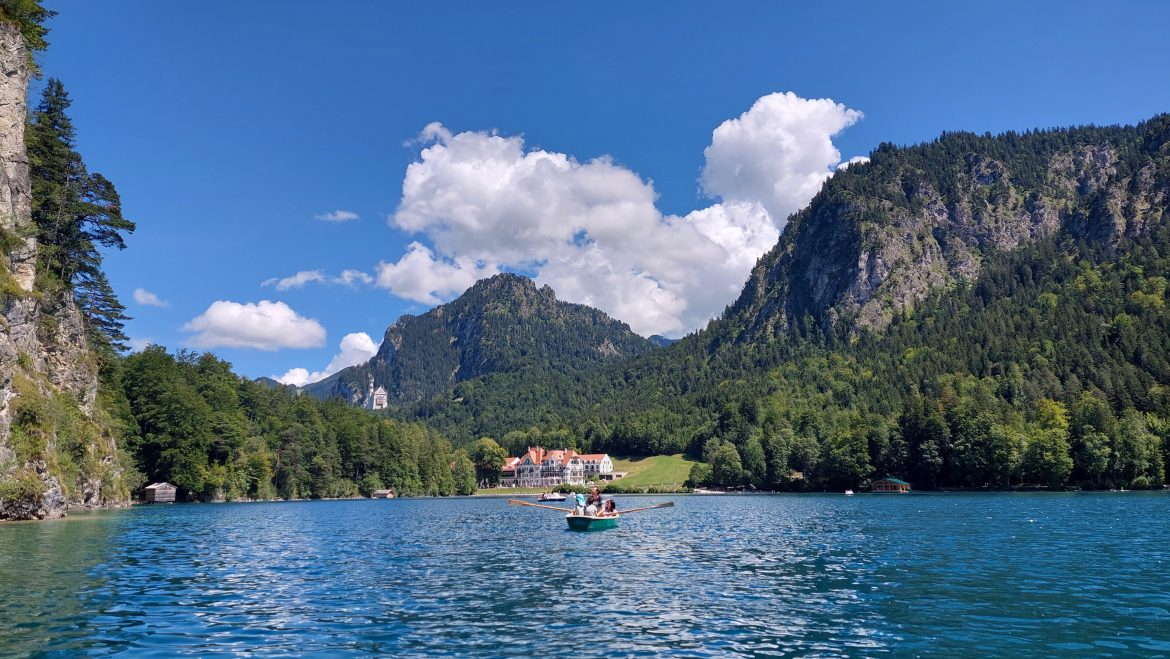 alpsee-hohenschwangau-rowboat-bavaria-germany rowboat on alpsee lake in hohenschwangau with view of neuschwanstein castle, bavaria-germany