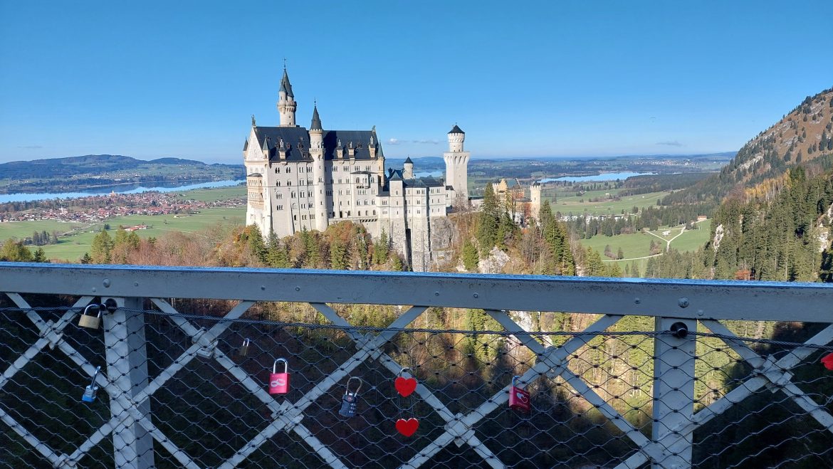 neuschwanstein-castle-marien-bridge-locks-bavaria-germany neuschwanstein castle view from marienbrücke with love locks on railing in autumn, bavaria-germany