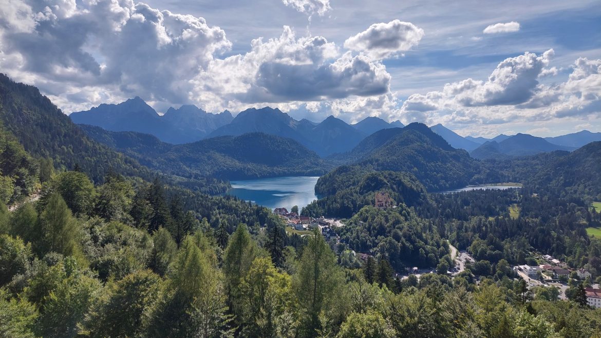 neuschwanstein-castle-view-from-balcony-alpsee-hohenschwangau-bavaria-germany balcony view from neuschwanstein castle with alpsee and hohenschwangau castle in the background in summer, bavaria-germany