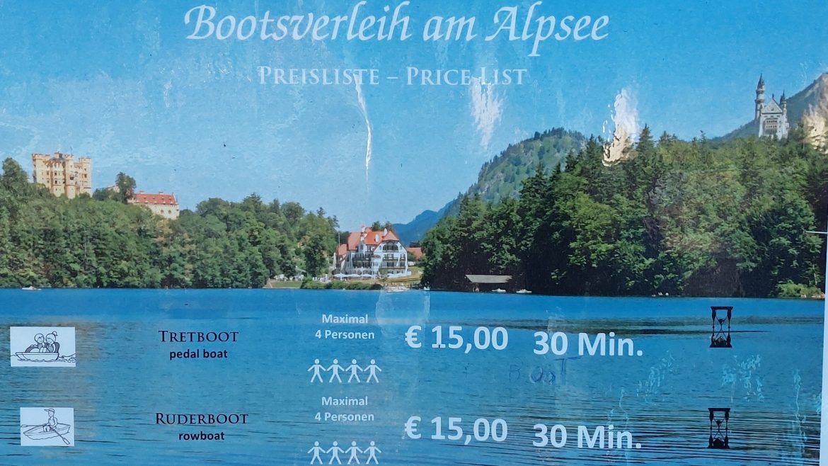 price-info-rental-alpsee-pedalboat-rowboat-hohenschwangau-bavaria-germany price info sign for pedalboat and rowboat rental on alpsee hohenschwangau, bavaria-germany