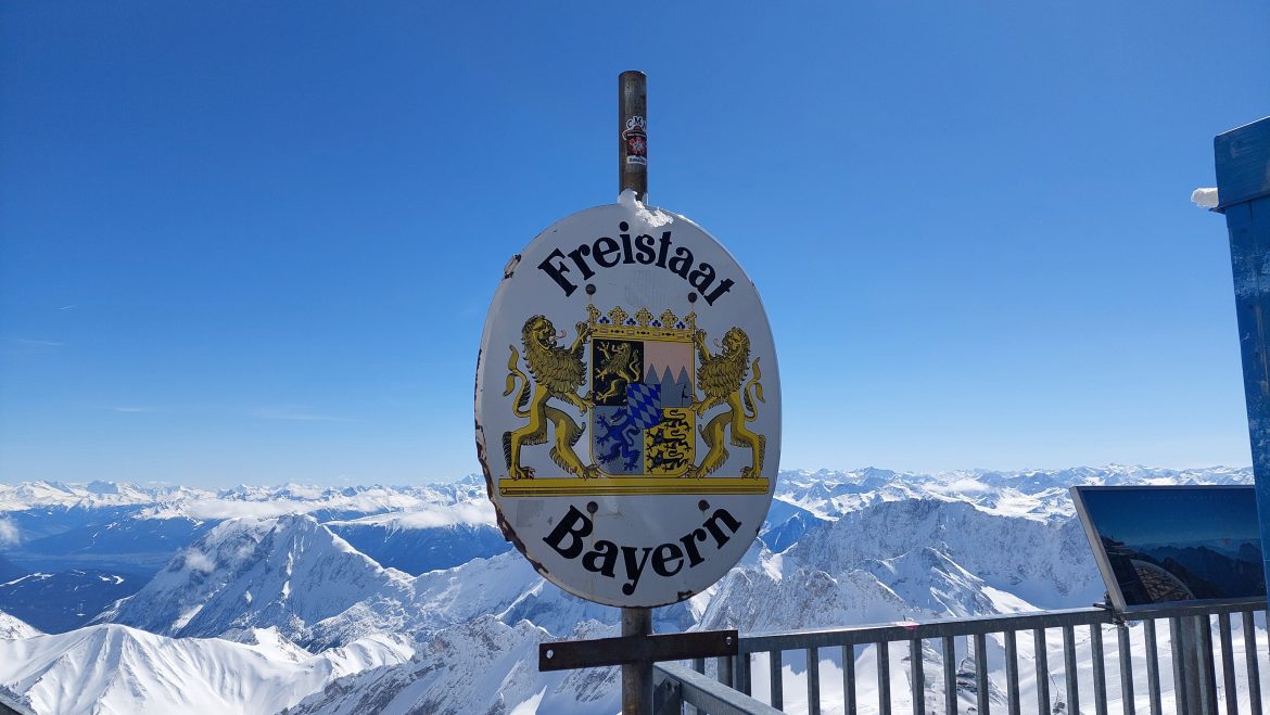 free-state-of-bavaria-zugspitze-sign-germany Free State of Bavaria sign with snowy Zugspitze mountains, Germany