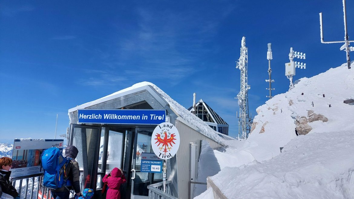 zugspitze-austrian-side-bavaria-germany Gate to Tyrolean side on Zugspitze summit platform, sunny March day, Bavaria, Germany