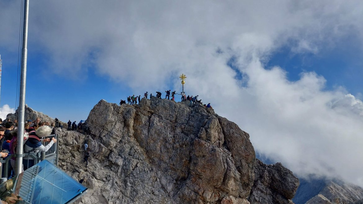 zugspitze-gold-cross-bavaria-germany Golden cross on Zugspitze summit with line of climbers, Bavaria, Germany