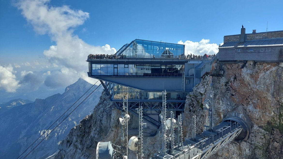 zugspitze-top-from-austrain-side-bavaria-germany Zugspitze summit view from Austrian side with Eibsee cable car and blue sky, Bavaria, Germany
